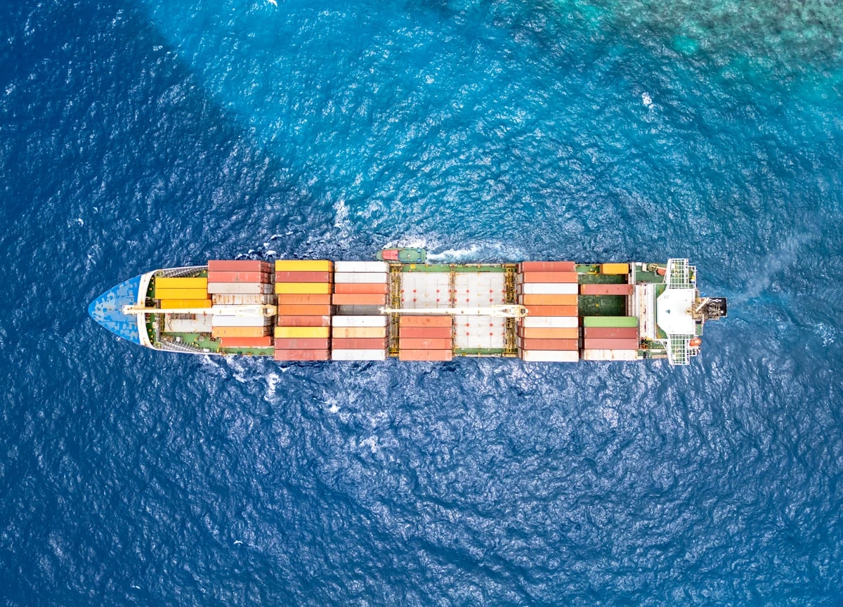 Aerial view of a cargo ship crossing open water